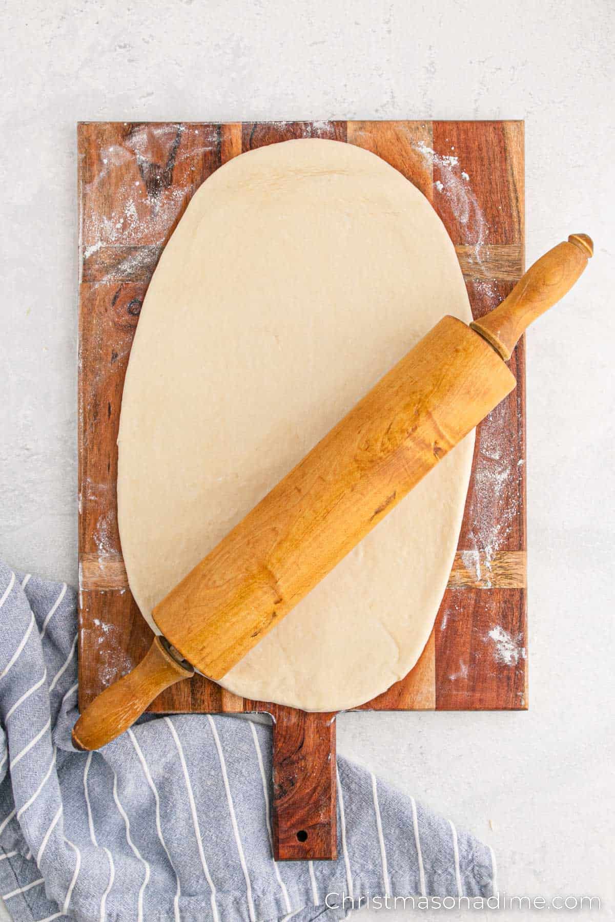 Rolling dough with a rolling pin a floured surface