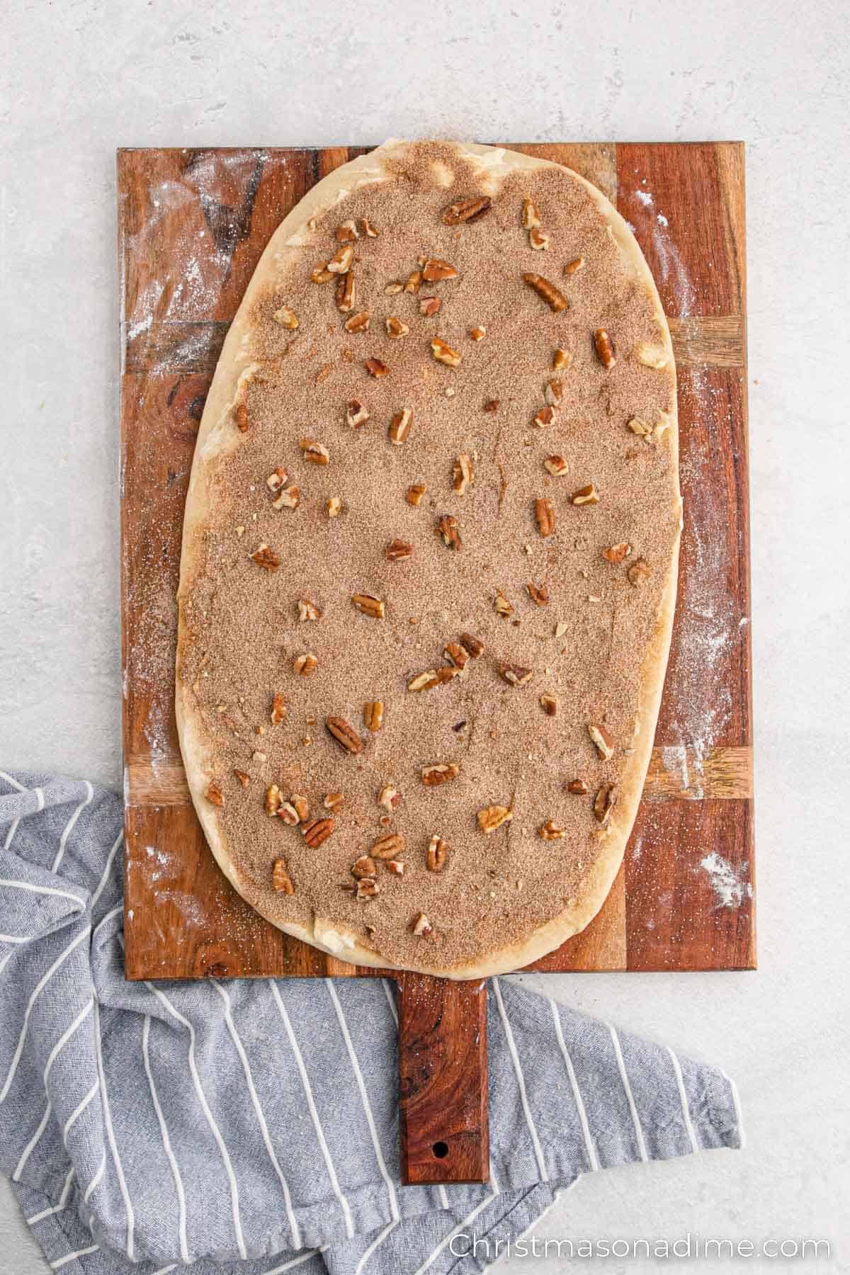 Cinnamon and sugar sprinkled over the dough with chopped nuts