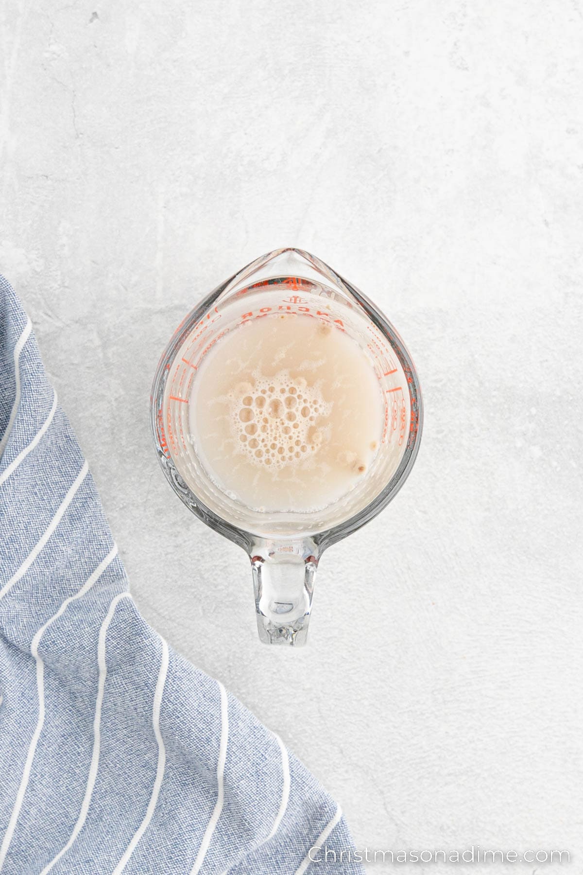 Warm water mixed with yeast in a glass bowl