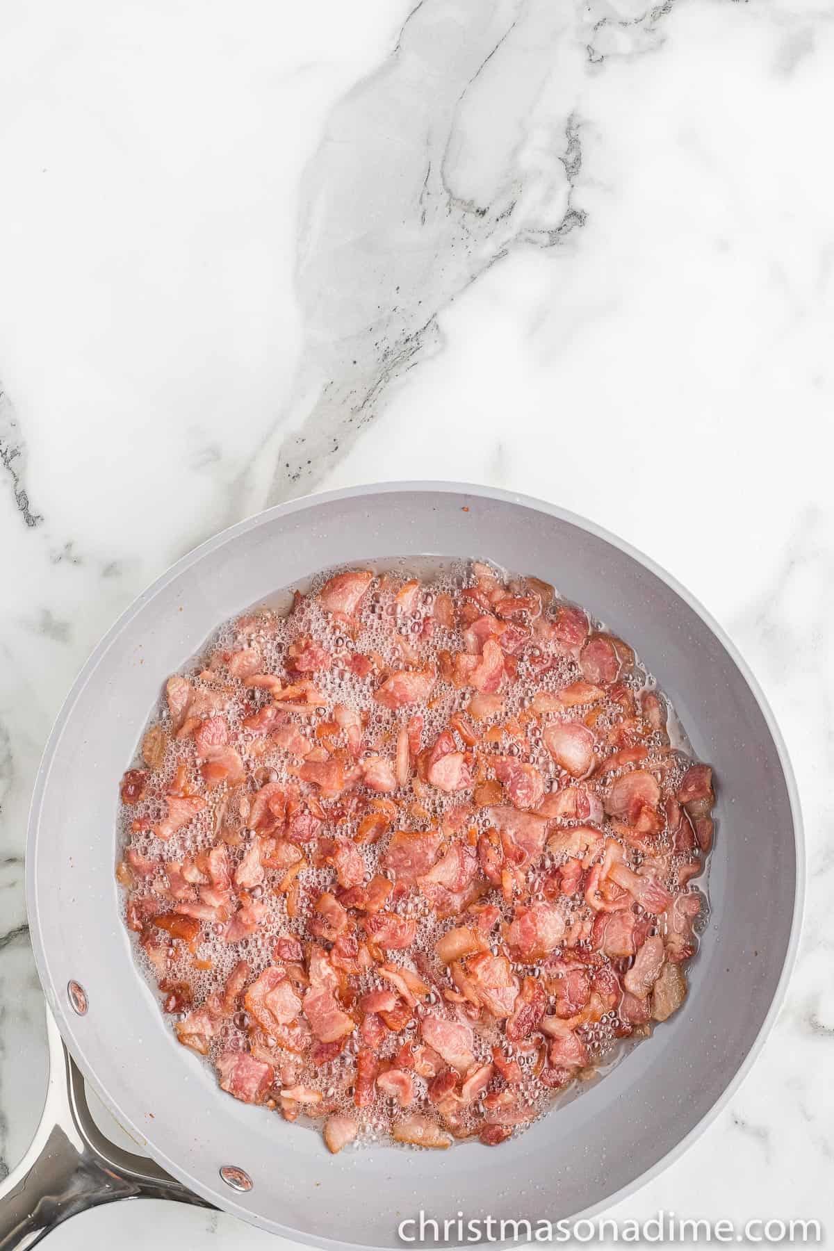 Cooking chopped bacon in a skillet