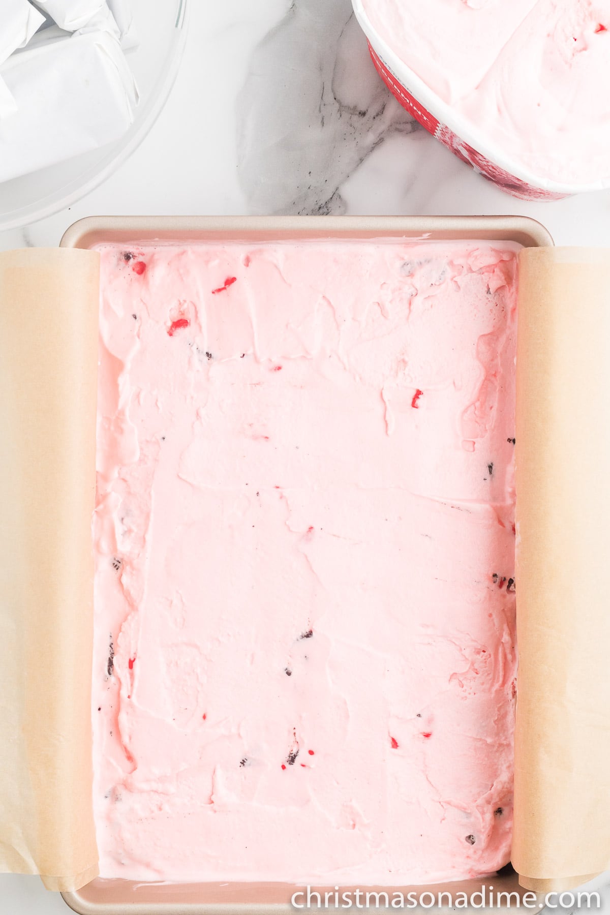 Layering the peppermint ice cream in the cake pan