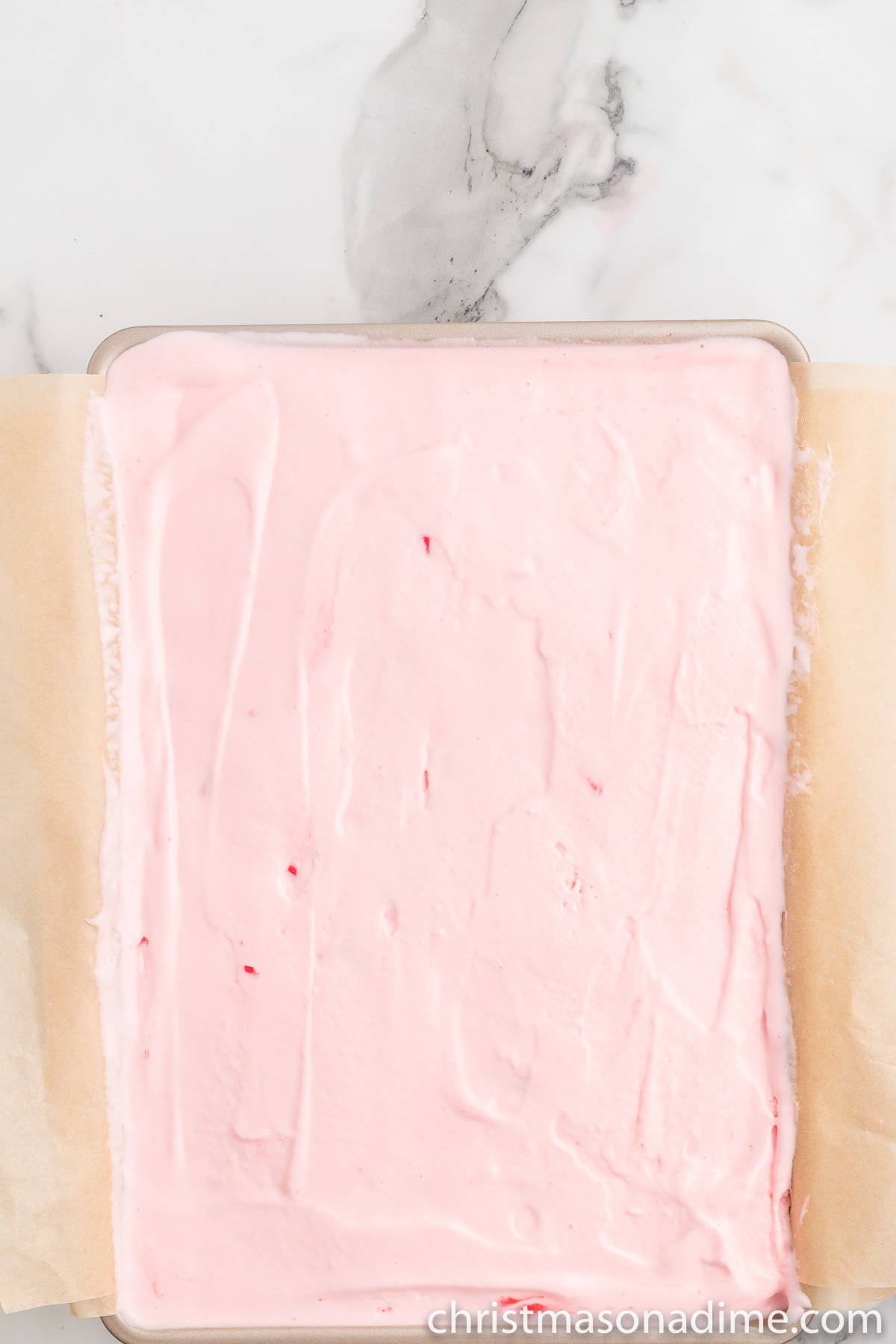 Spreading the peppermint ice cream in the cake pan