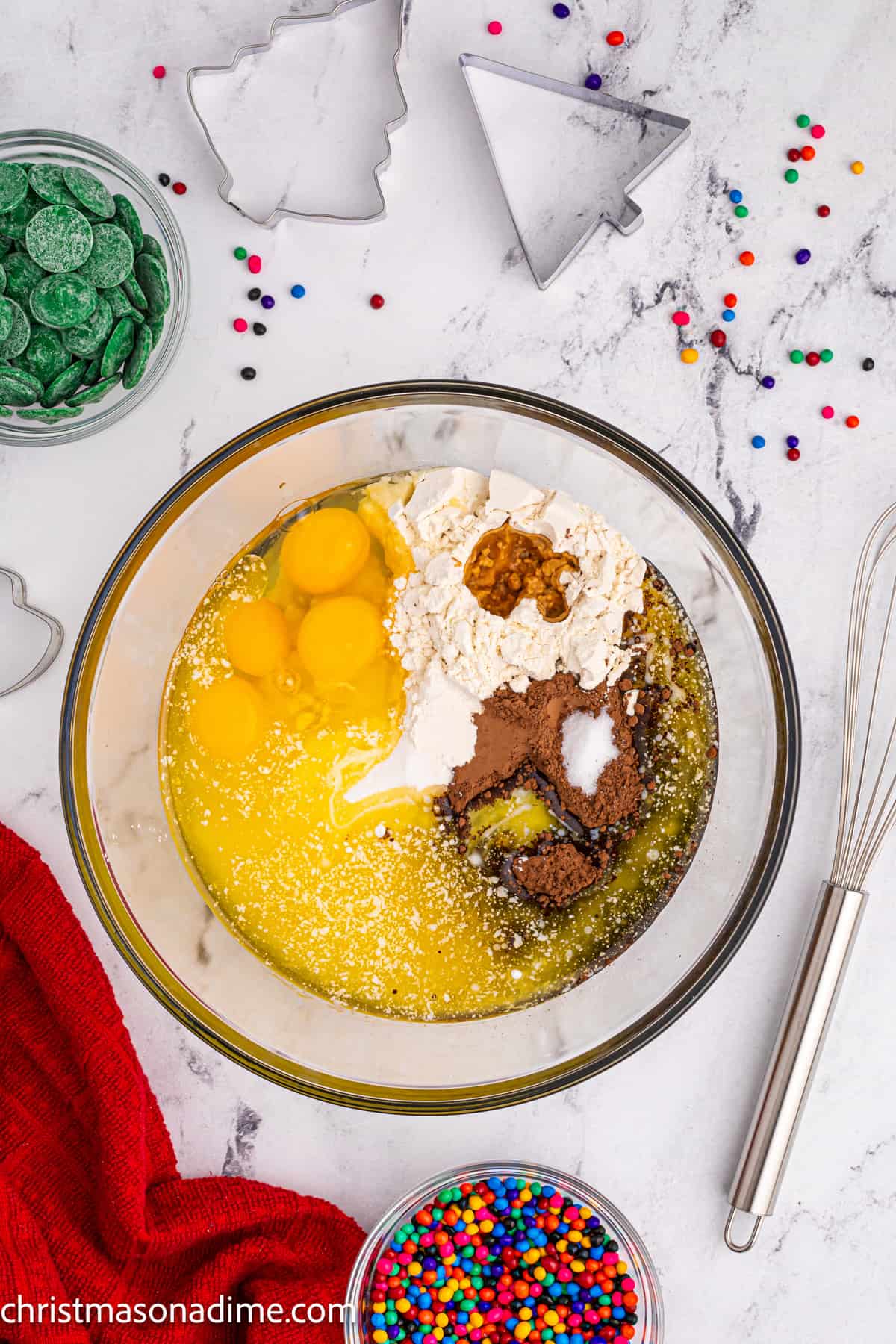 Combining the brownie ingredients together in a clear bowl