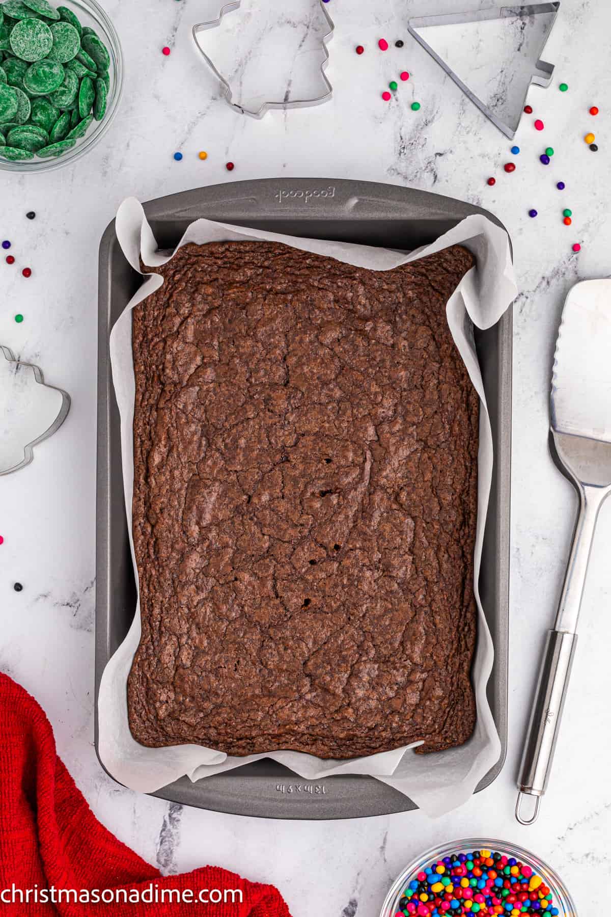 Baked brownie in a baking dish with parchment paper