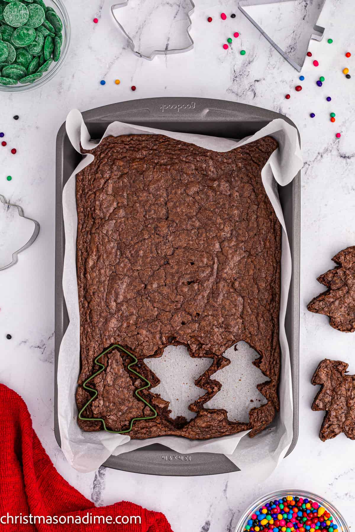 Christmas Tree Cookie Cutter pressed into a pan of brownies